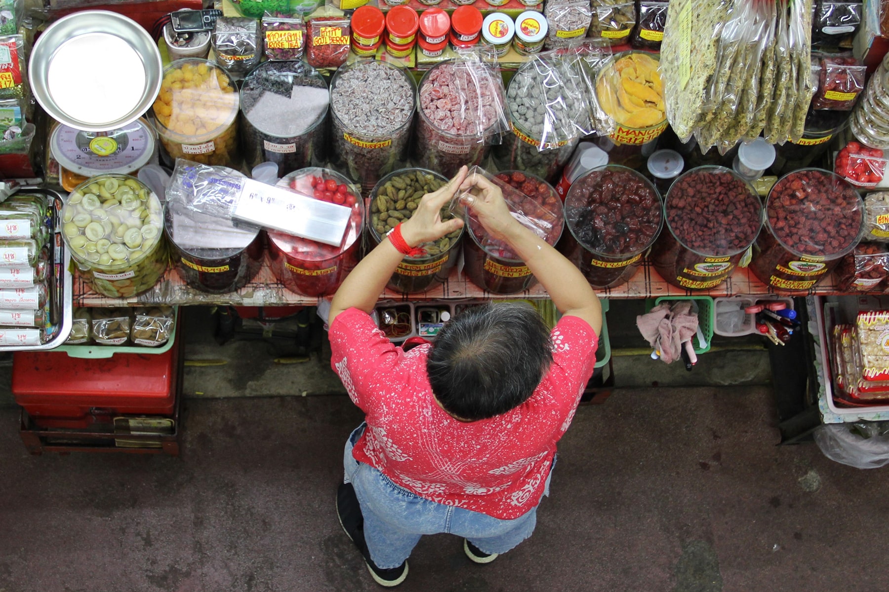 Olive seller in Chiang Mai market from above